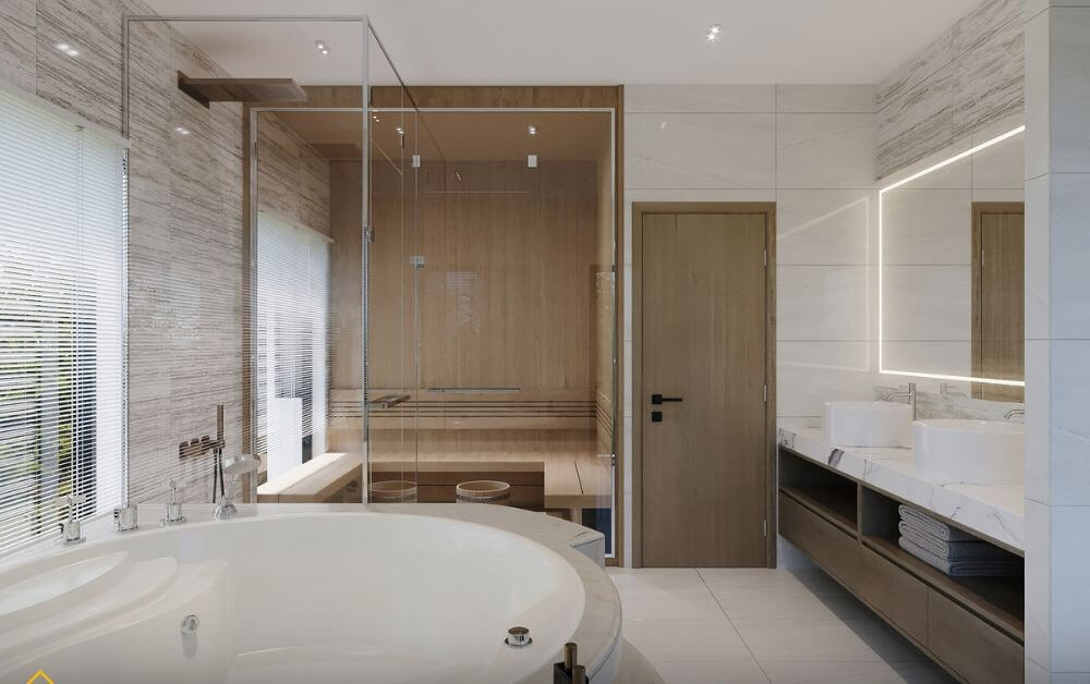 Phòng tắm sang trọng với bồn tắm tròn, cửa kính và gương sáng, không gian hiện đại.