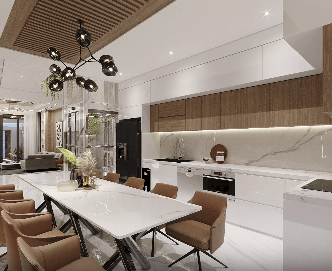 Phòng bếp hiện đại với bàn ăn lớn, ánh sáng đèn sang trọng và tủ bếp màu trắng, gỗ tự nhiên.
