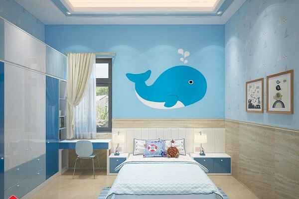 Phòng ngủ trẻ em trang trí màu xanh với hình cá voi dễ thương trên tường, bàn học cạnh cửa sổ.