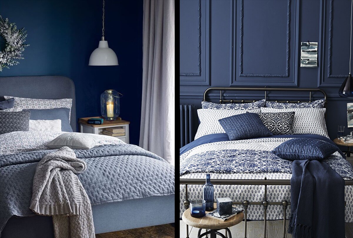 Phòng ngủ sang trọng với giường và chăn gối màu xanh đậm, trang trí hiện đại và ánh sáng ấm áp.