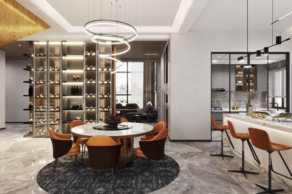 Phòng ăn sang trọng với bàn tròn, ghế da cam, đèn trang trí và tủ rượu cao cấp bên cạnh bếp hiện đại.