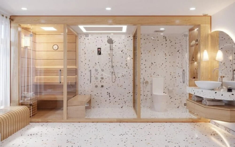 Phòng tắm hiện đại với phòng xông hơi và vòi sen, thiết kế nội thất sang trọng với đá terrazzo và gỗ sáng.