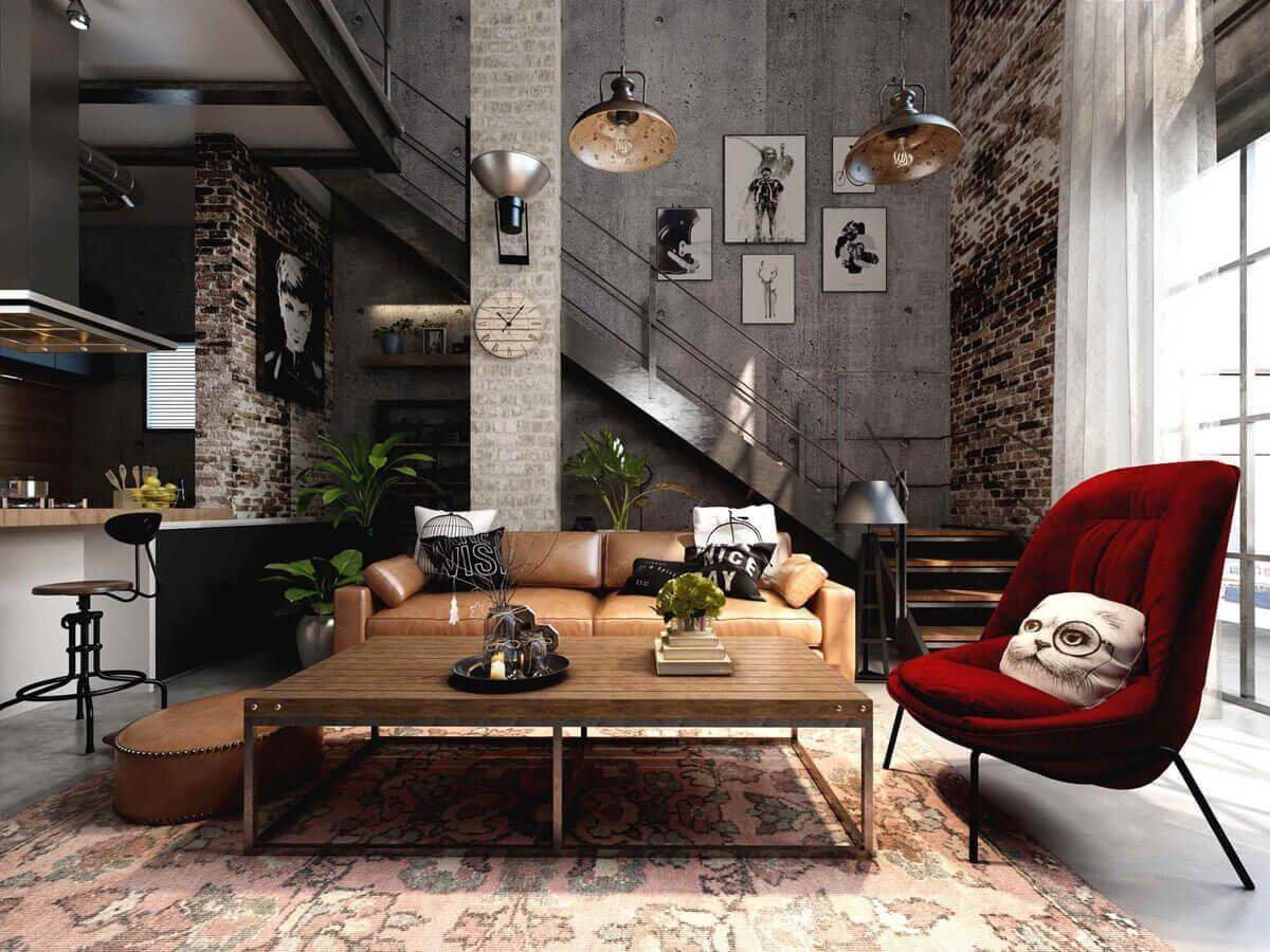 Phòng khách phong cách công nghiệp với ghế sofa da nâu, ghế đỏ, tranh treo tường và lối cầu thang gạch.